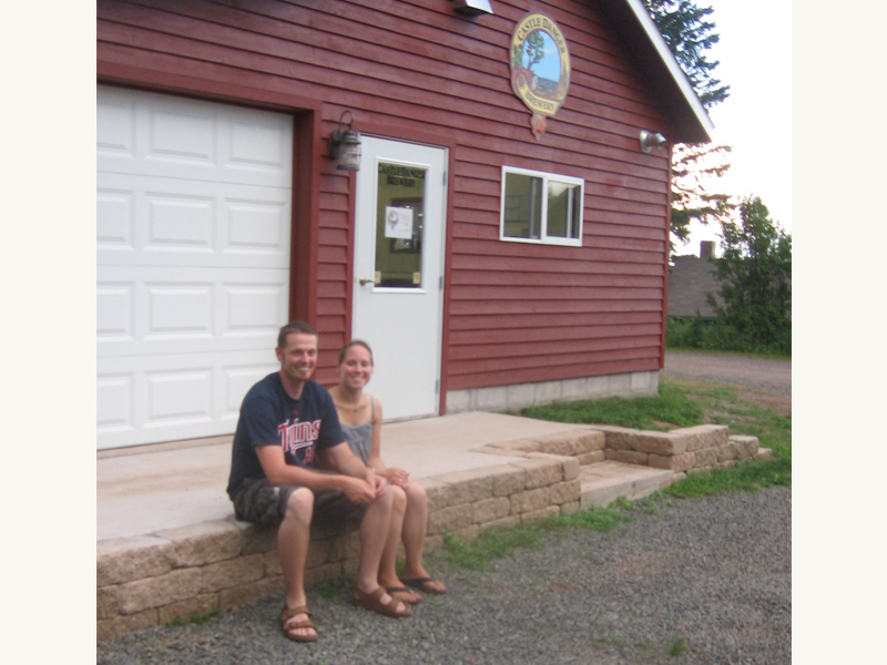 Clint and Jamie (founders) sitting outside of the original brewery, their garage.