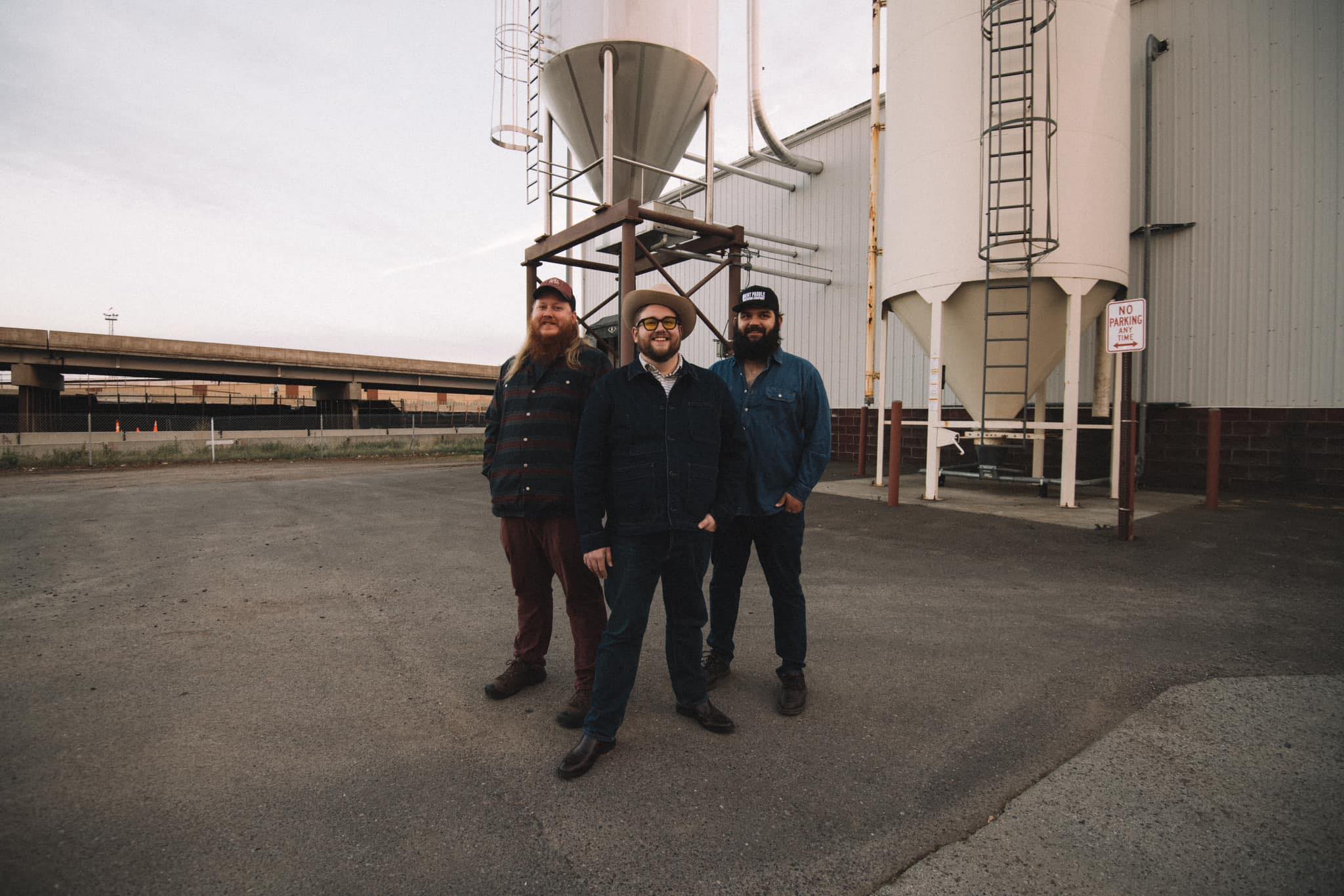 photo of the band Tres Osos in front of grain silos